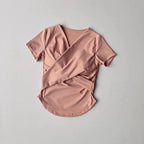 Female quick dry sports top with built in cup in soft pink color, perfect for yoga and workouts.