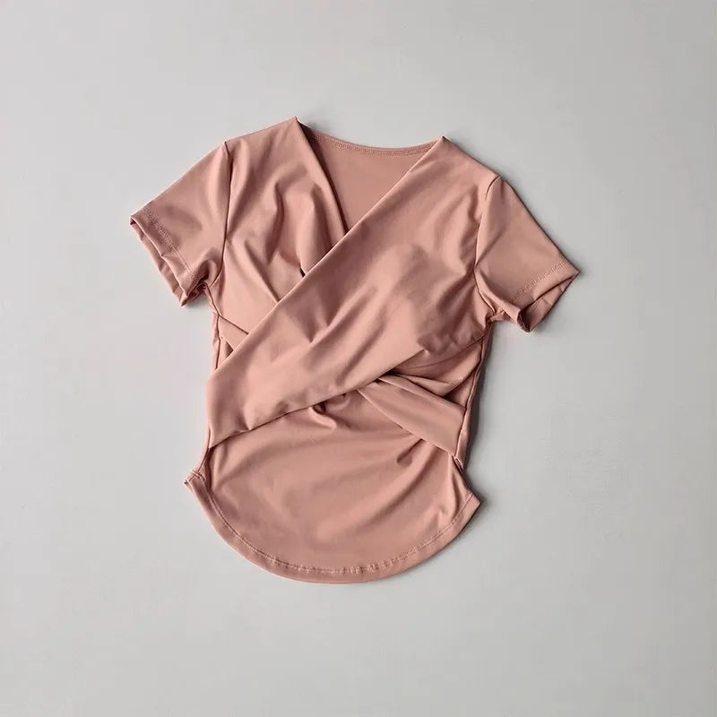 Female quick dry sports top with built in cup in soft pink color, perfect for yoga and workouts.
