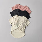 Set of three female quick dry sports tops with built in cup in pink, black, and cream colors