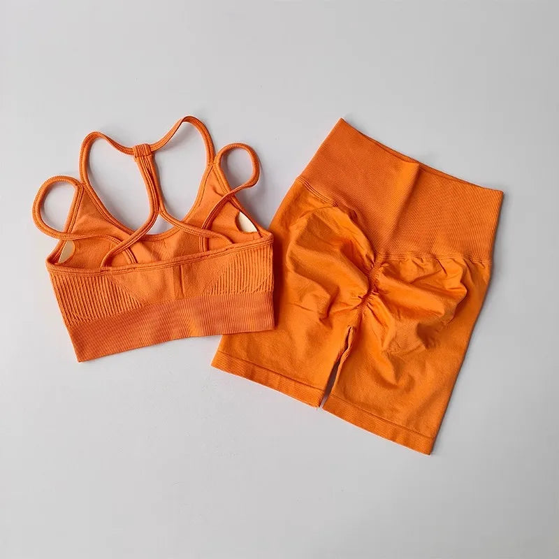 Bright orange fitness bra and shorts set featuring a stylish crisscross design and flattering fit