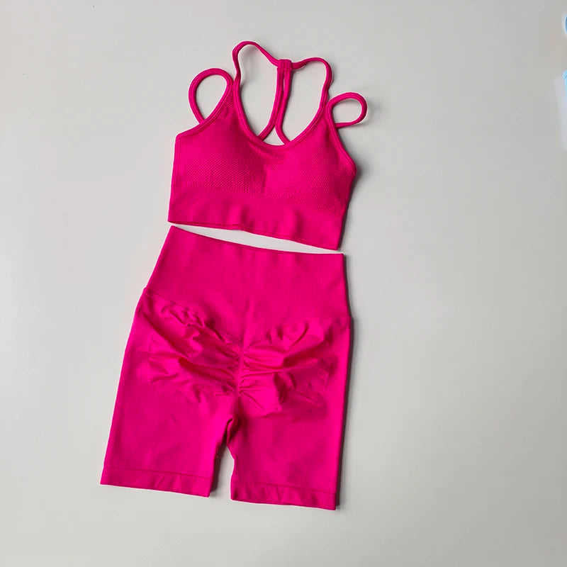 Bright pink fitness bra and shorts set with stylish design for active wear enthusiasts