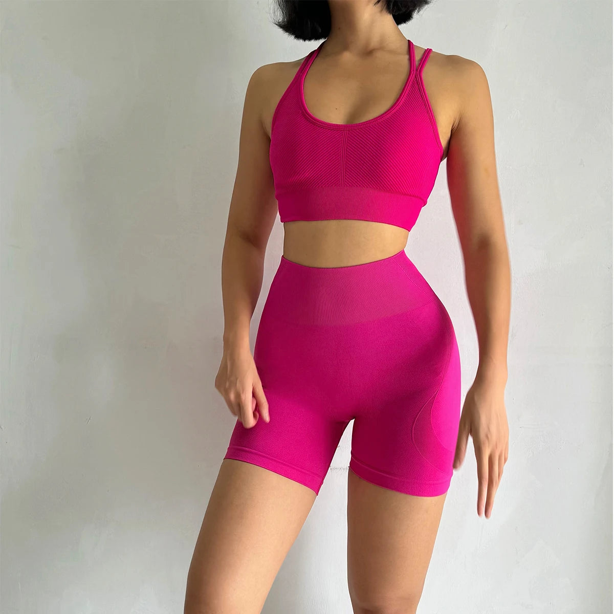 Bright pink fitness bra and shorts set designed for comfort and performance during workouts