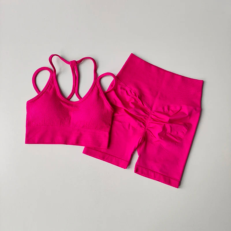Vibrant pink fitness bra and shorts set designed for comfort and style during workouts