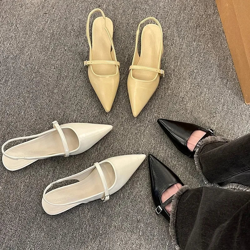 French chic diamond buckle flats in beige white and black shown on carpet with person wearing black flats