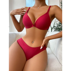 Red front button bralette and panties set by The Lady's Haven Boutique modeled indoors on couch