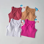 Four colorful front zipper fitness bras in pink, white, nude, and red for stylish workouts