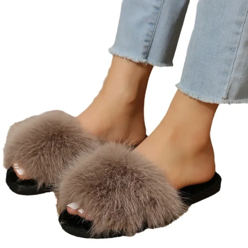 The Lady's Haven Boutique fuzzy flat slide slippers in taupe with plush fur and black sole worn with cropped jeans