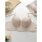 Beige gathering push up bra for ladies by The Lady's Haven Boutique laid flat with pearls and magazine