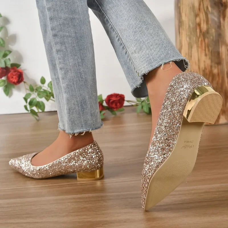 Glittery flats for parties in sparkling gold with low block heels worn with light wash jeans