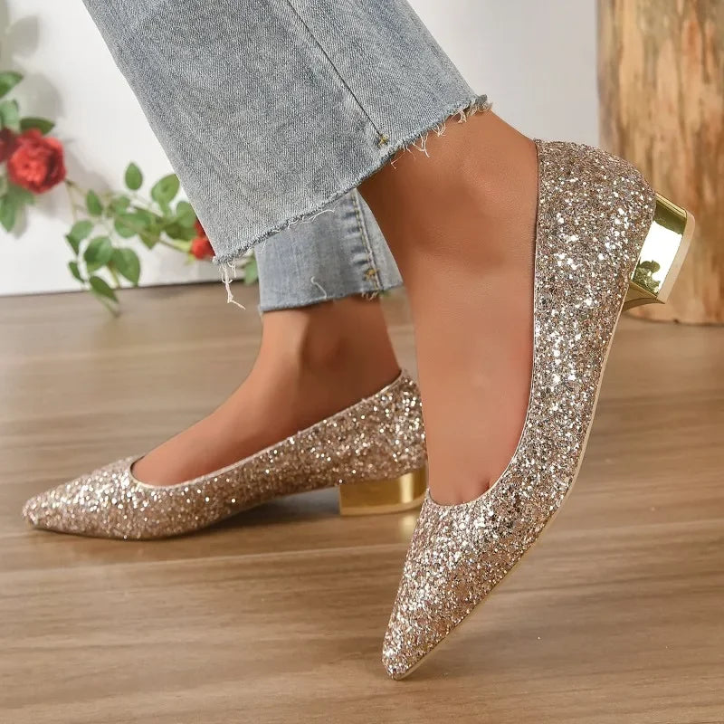 Gold glittery flats for parties with low metallic block heel worn with frayed hem jeans