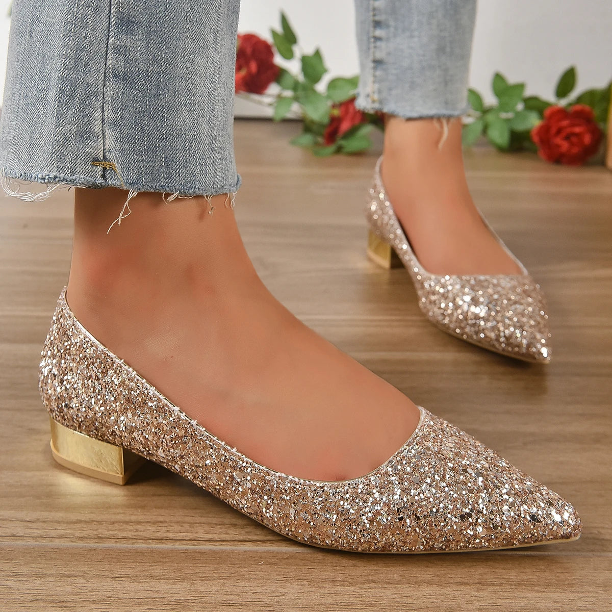 Glittery flats for parties in gold sparkle with low block heel worn with light wash jeans