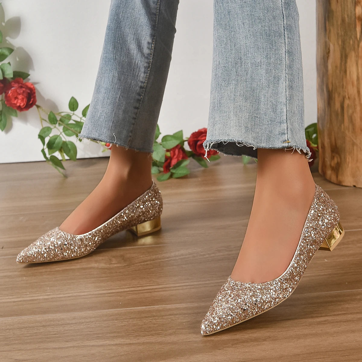 Glittery flats for parties in gold sparkle with low block heels worn with cropped jeans