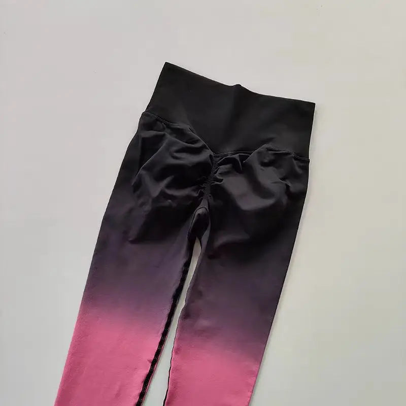 Gradient running leggings in black and pink with a comfortable high waist design for activewear