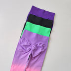 Gradient running leggings in a stylish blend of purple, black, and green colors for active wear