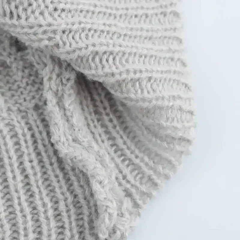 Close-up of soft light gray knitted cropped sweater cardigan fabric texture by The Lady's Haven Boutique