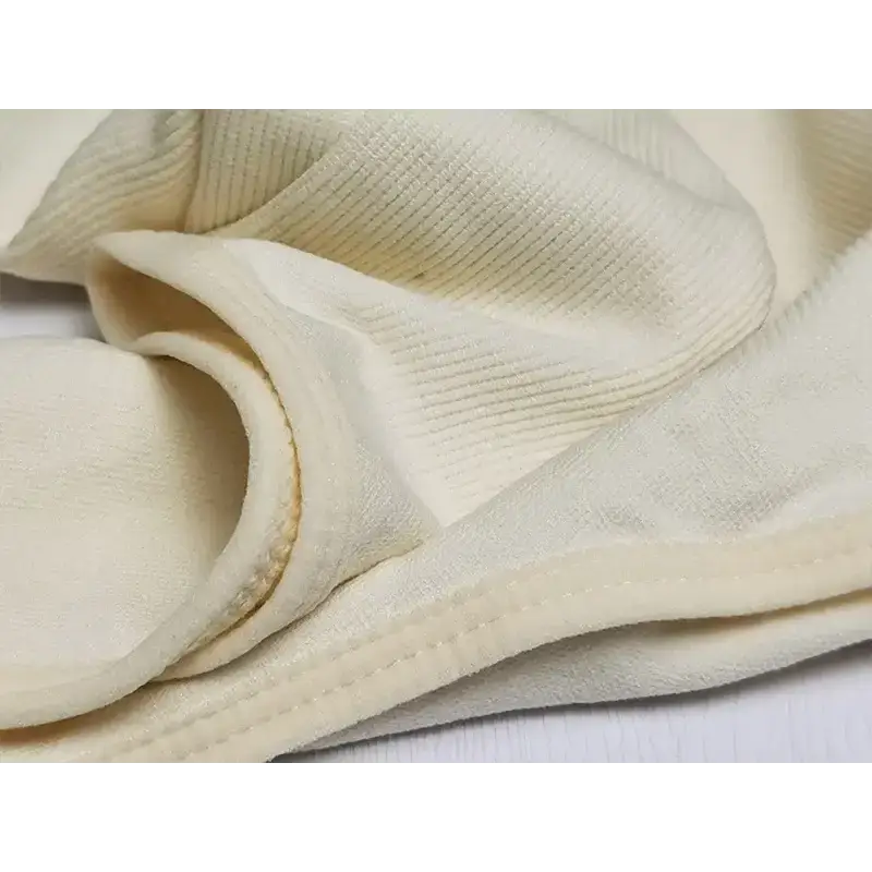 Close-up view of cream fabric texture and stitching details on big u neck shapewear bodysuit
