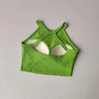 Green gym top fitness camisole with unique cut-out design for stylish workouts