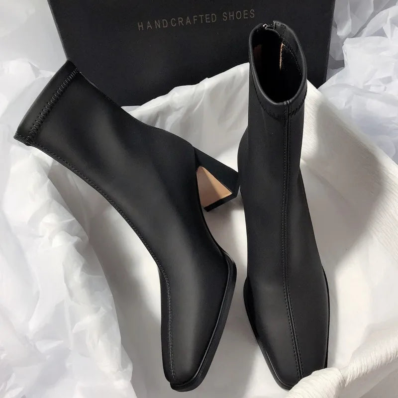 Black fashion boots with back zipper featuring a sleek square toe and high heel from The Lady's Haven Boutique