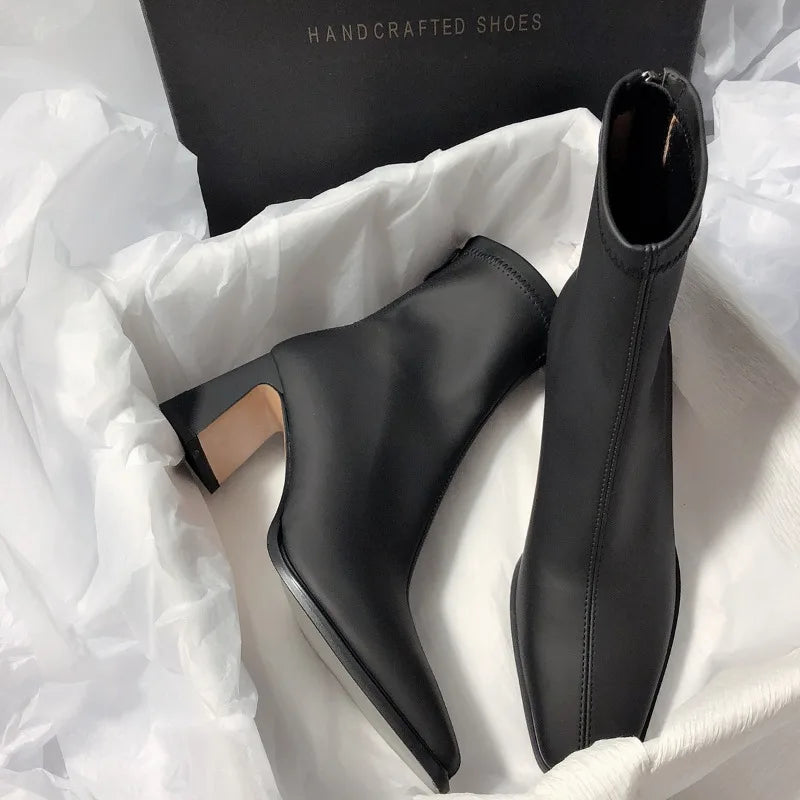 Black fashion boots with back zipper featuring a block heel and sleek design from The Lady's Haven Boutique