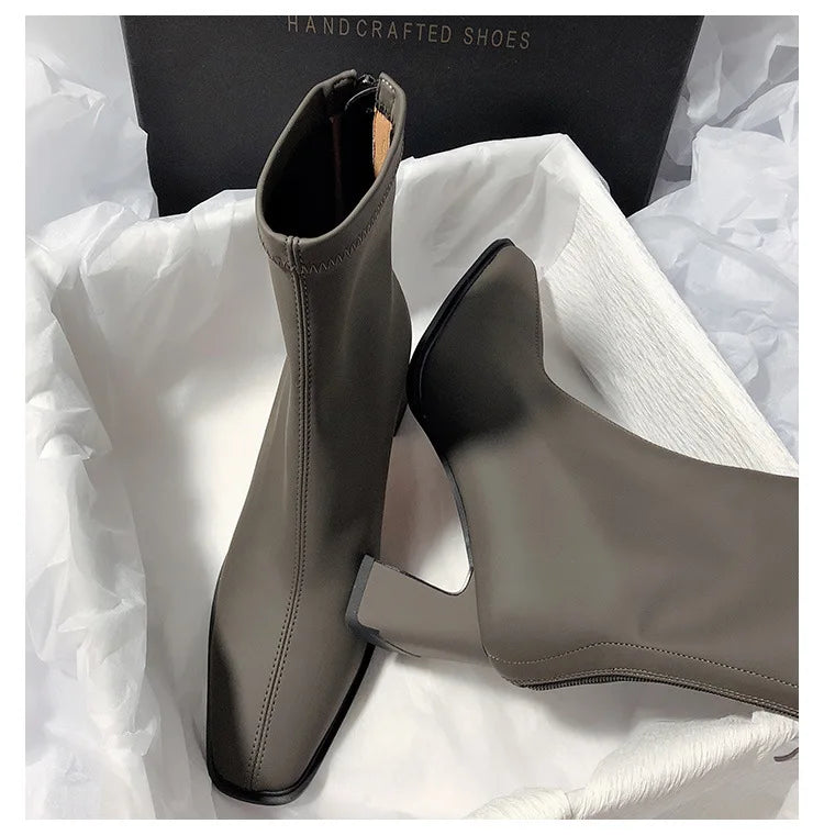 Gray fashion boots with back zipper featuring a sleek square toe and block heel from The Lady's Haven Boutique