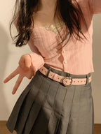 Stylish heart buckle waist belt in pink paired with a pleated skirt for a trendy look
