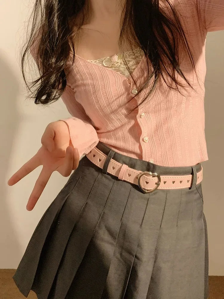 Stylish heart buckle waist belt in pink paired with a pleated skirt for a trendy look