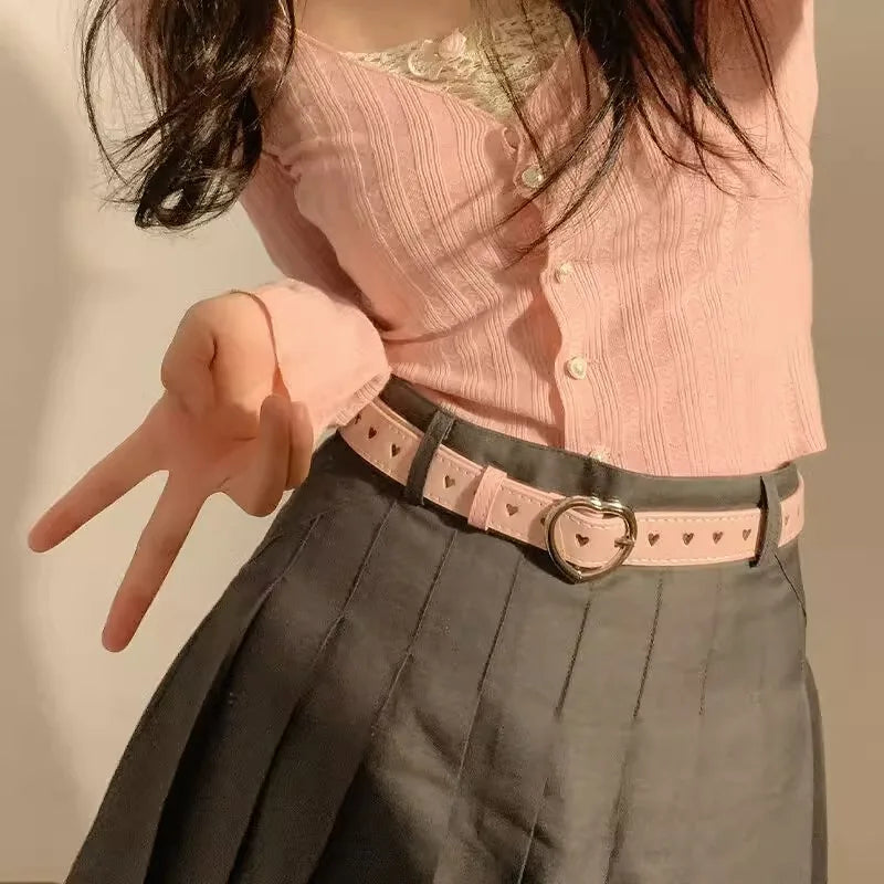 Heart buckle waist belt with pink design, adding a stylish touch to outfits at The Lady's Haven Boutique
