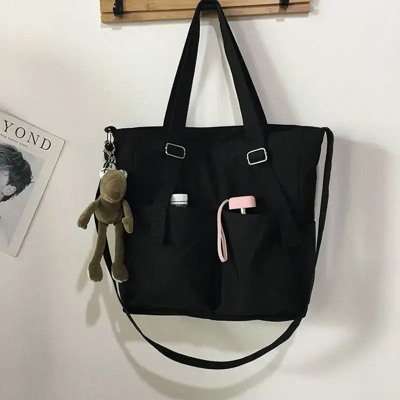 High capacity waterproof nylon handbags in black with multiple pockets and adjustable straps