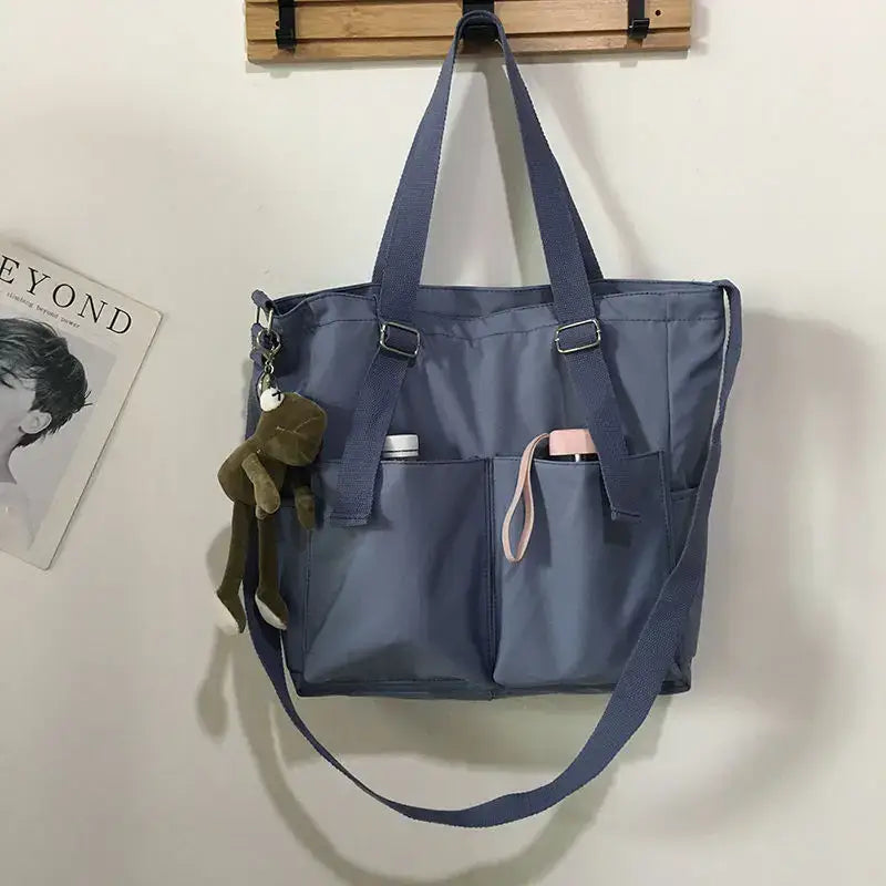 High capacity waterproof nylon handbags in gray with multiple pockets and detachable charm