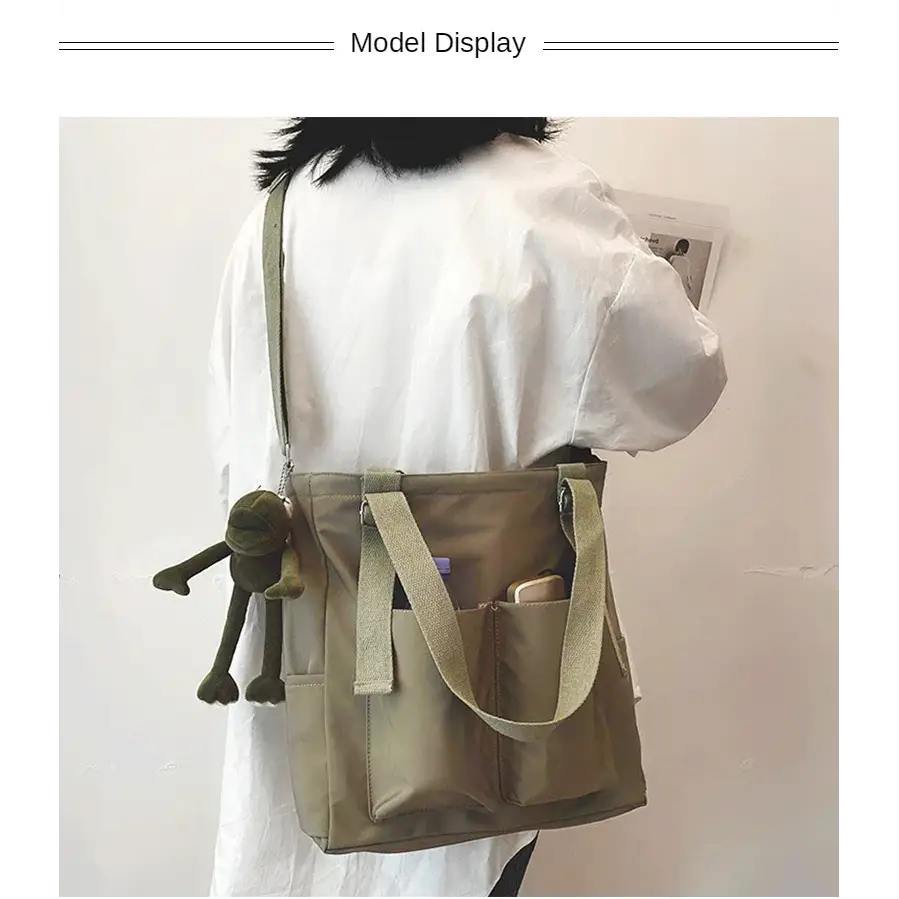 Stylish model showcasing high capacity waterproof nylon handbags with a cute plush accessory