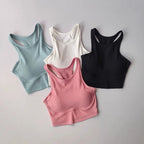 Four high impact sports bras for women in blue, white, black, and pink colors with racerback designs