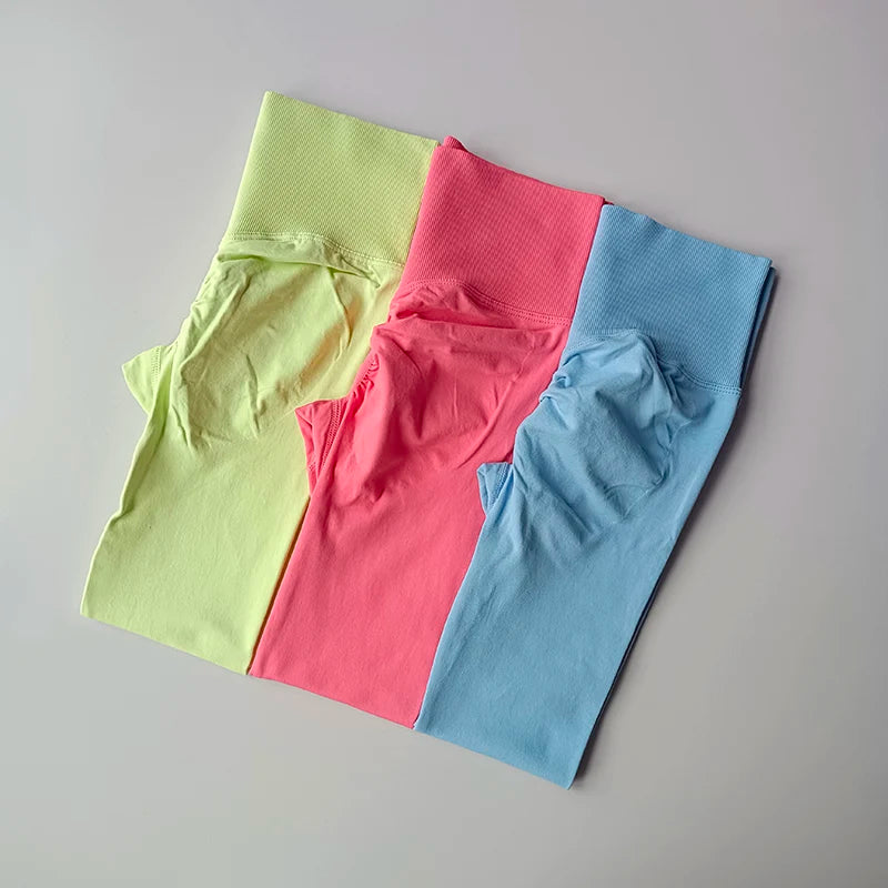 Three pairs of high waist seamless yoga leggings in neon green, pink, and blue colors