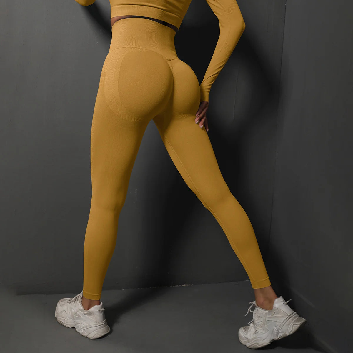 High waist seamless yoga leggings in mustard yellow color, designed for comfort and flexibility during workouts