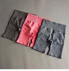 High waist seamless yoga shorts in black, pink, and gray for comfortable workouts and active lifestyle