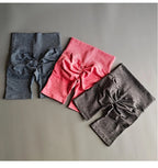 High waist seamless yoga shorts in three colors including pink, blue, and gray for comfortable workouts