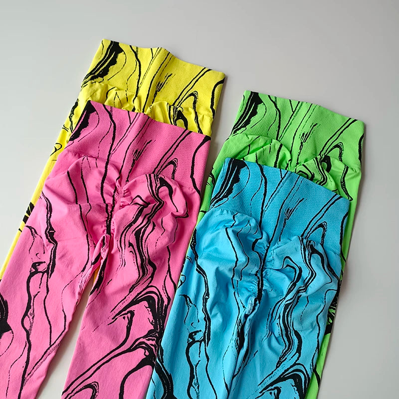 Colorful high waisted printed leggings in pink, blue, yellow, and green with trendy marble patterns