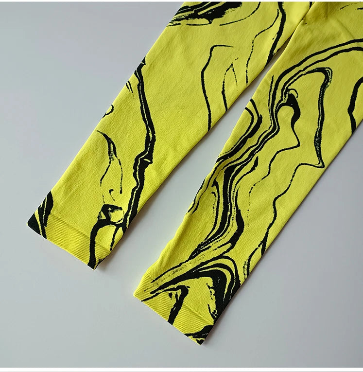 High waisted printed leggings in yellow with unique black marble design for stylish comfort