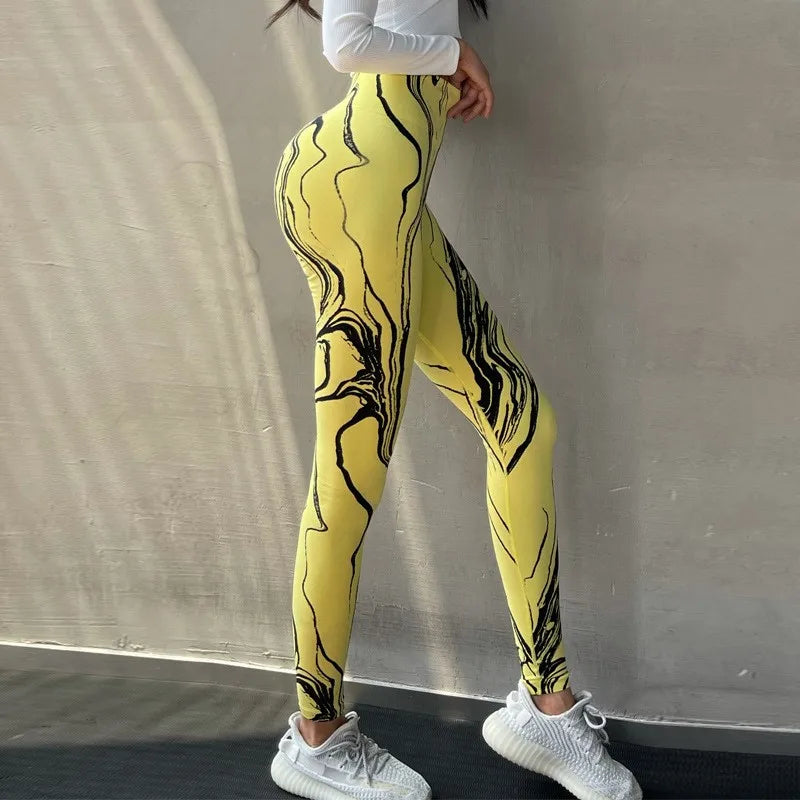 High waisted printed leggings in yellow with abstract black design, ideal for stylish workouts