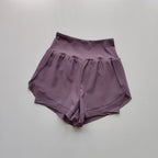 High-waisted sports shorts women in lavender color with side pockets for comfort and style