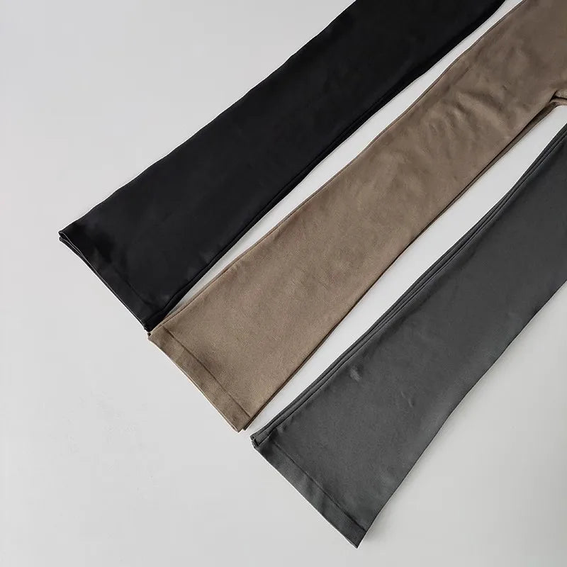Three pairs of high waisted yoga pants bell-bottoms in black, beige, and gray for comfortable workouts