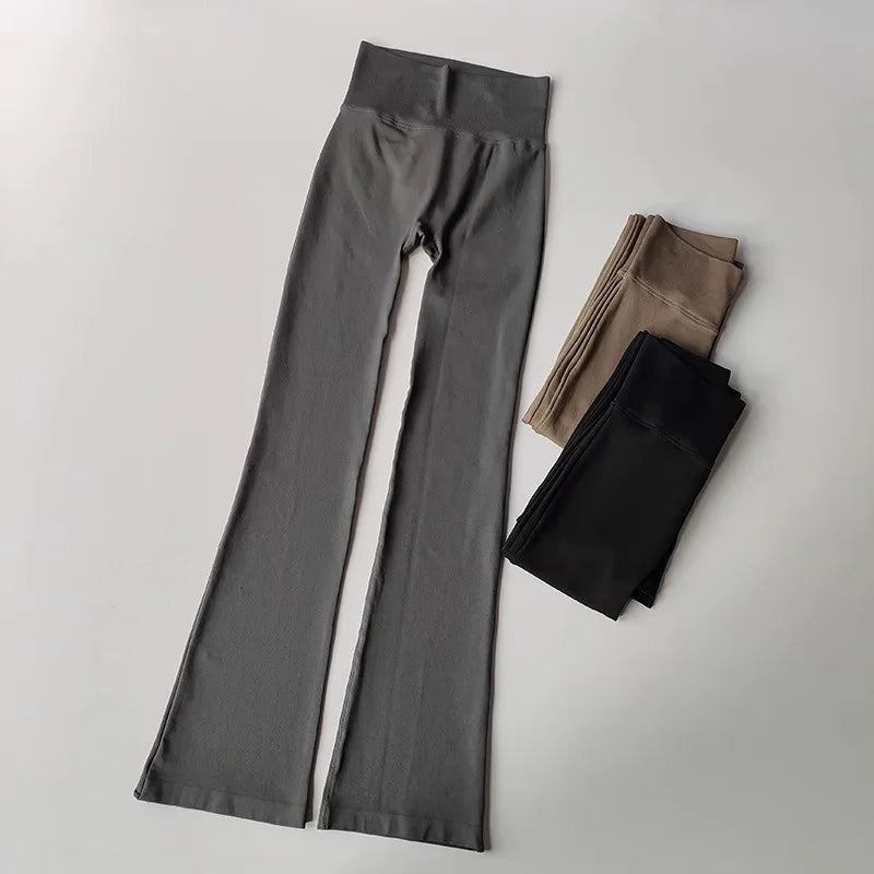 High waisted yoga pants bell-bottoms in gray with black and tan pairs folded beside them