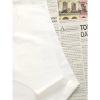 White hip lifting seamless panties for women displayed on newspaper background