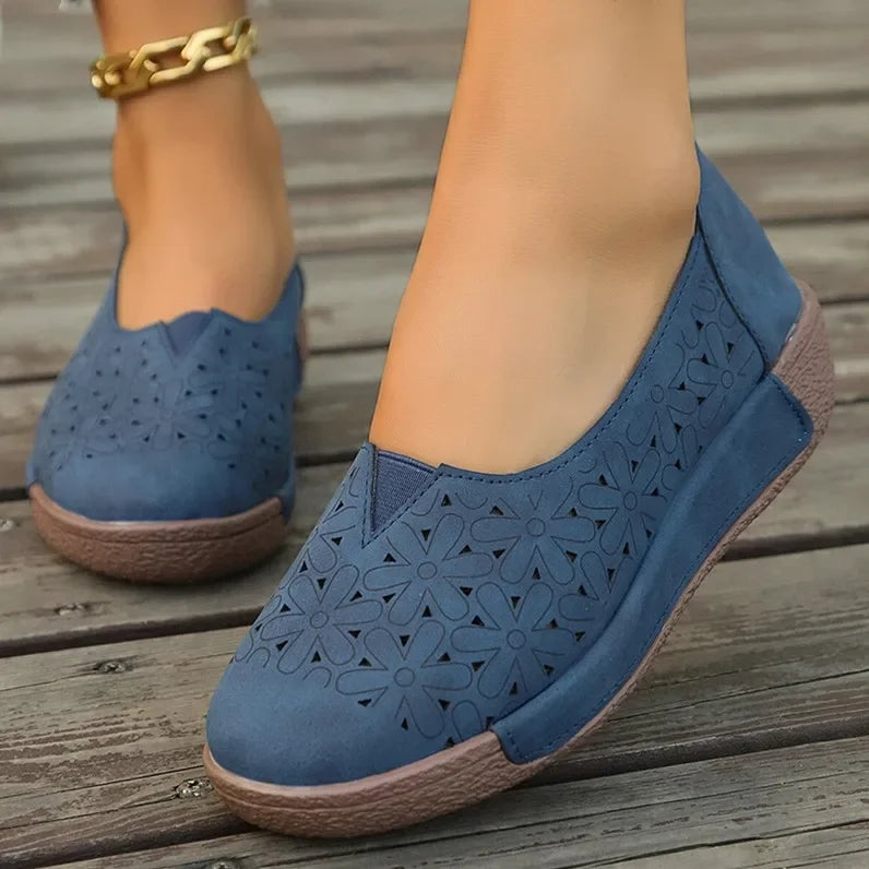 Blue hollow out casual shoes for ladies with floral cut-out design and comfortable brown soles