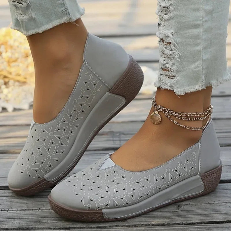 Gray hollow out casual shoes for ladies with floral cutout design and brown sole