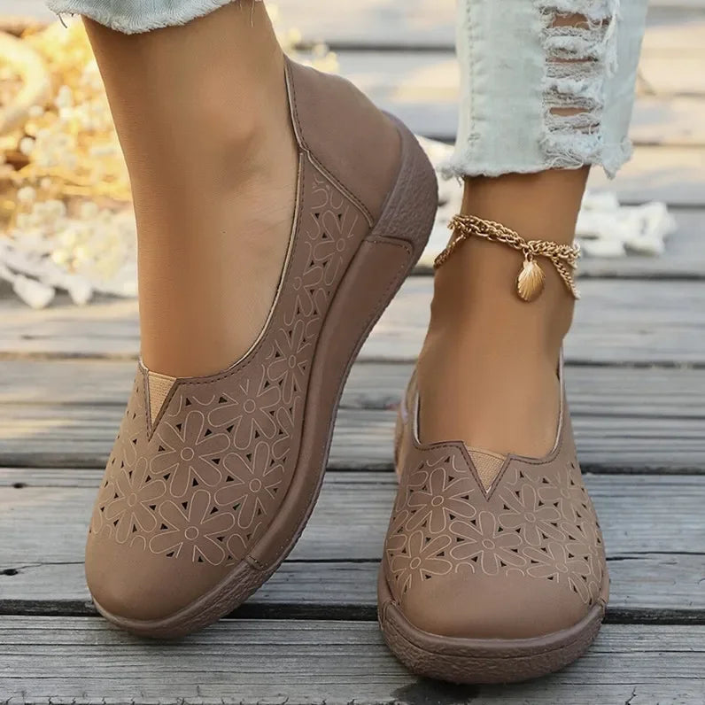 Brown hollow out casual shoes for ladies with floral cutout design worn with ankle bracelet