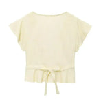 Cream short sleeve blouse and pant set top with a back tie detail from The Lady's Haven Boutique
