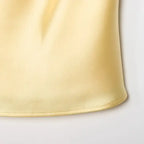 Close-up of soft yellow fabric detail of halter crop tops from The Lady's Haven Boutique