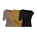 The Lady's Haven Boutique collection of spring fashion tops for ladies in black, mustard, and taupe colors