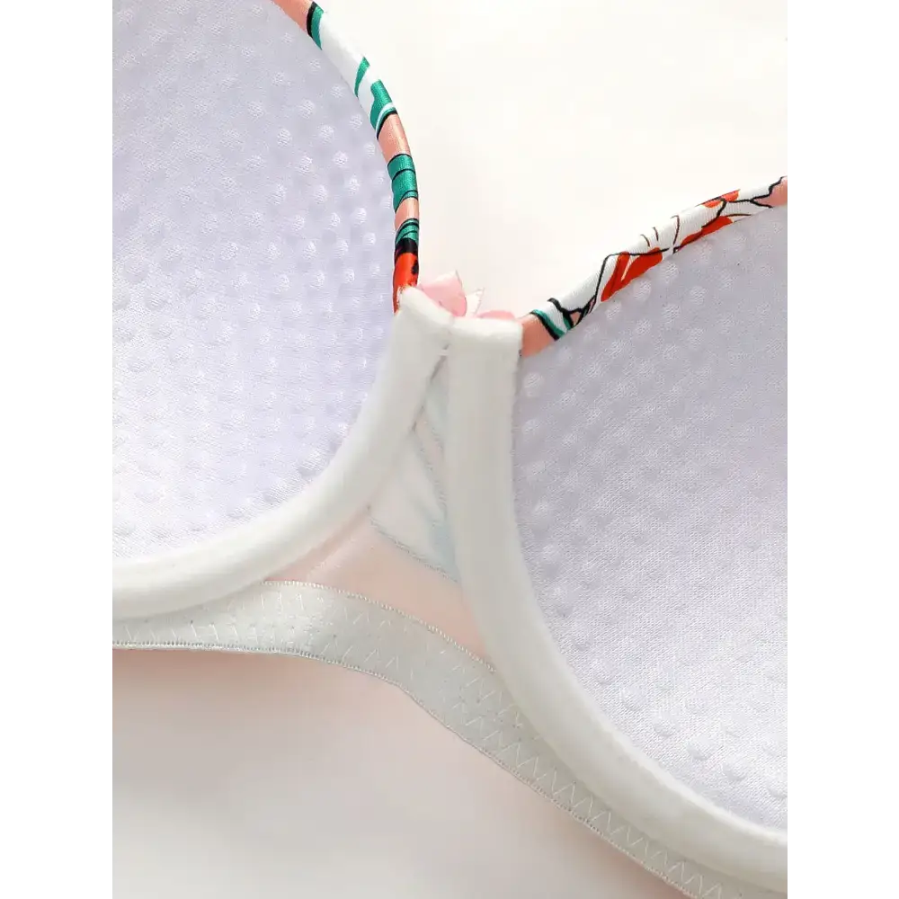 Close-up of white padded cups with floral trim on island vacation bra and panty set from The Lady's Haven Boutique