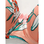 Close-up of island vacation bra and panty set with floral pattern and pink bow detail